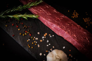 Raw lamb on a slate with ingredients